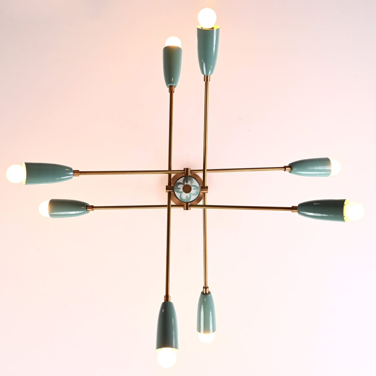 Top-down view of 8-light Sputnik chandelier with teal cone shades and brass arms, mid-century modern ceiling fixture.