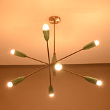Modern mid-century Sputnik chandelier in teal and brass illuminated warmly, featuring eight angled arms with cone shades.