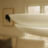 Close-up detail of textured white layered disc chandelier showcasing refined craftsmanship