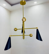 Hanging three cone brass chandelier with balanced geometric arms and warm brushed brass finish in a modern interior.
