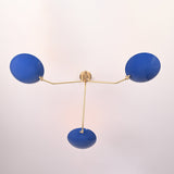 Bottom view of modern brass flush mount ceiling light highlighting three blue bowl shades