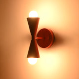 Two light red wall sconce creating warm ambient illumination with upward and downward globe bulbs