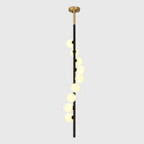 Vertical globe chandelier with cascading opal lights creating a luxury statement in a modern living room interior