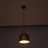 Whitewashed copper pendant light shown from front with compact rounded drum shade and warm interior glow